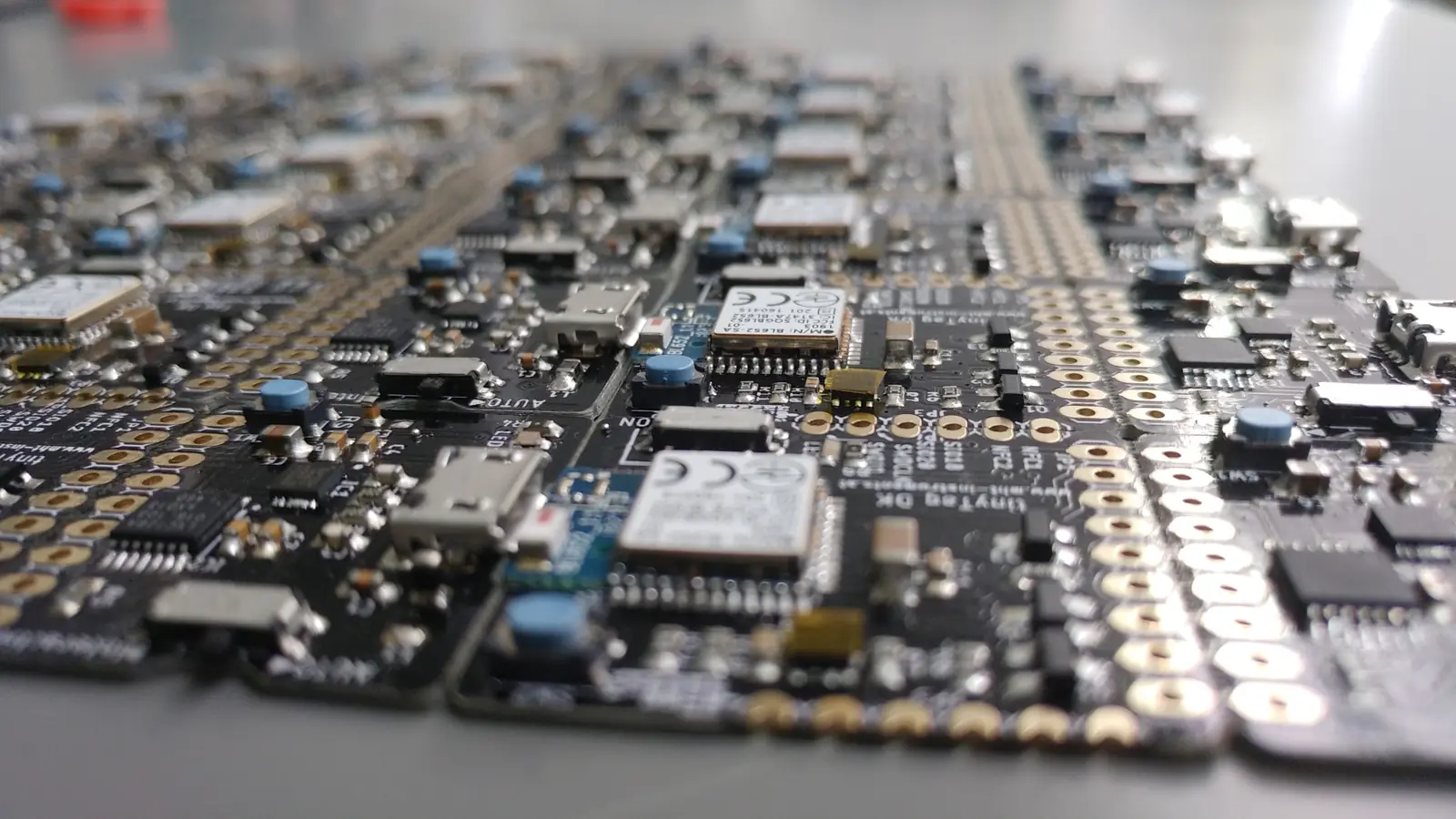 A panel of assembled tinyTag boards seen at a low angle